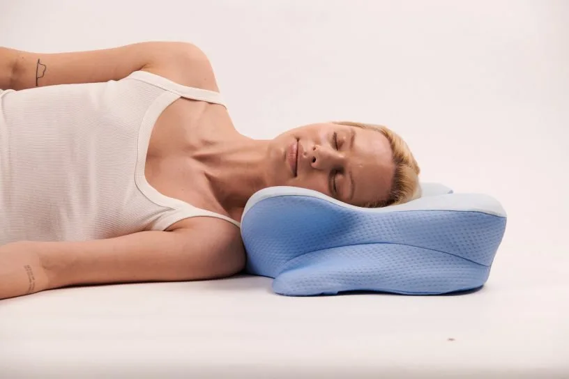 Sleeper's head and neck supported by a contoured pillow