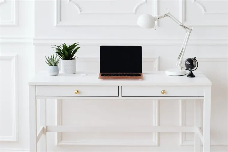 Minimal home office desk where a compact CosyJet heater would sit