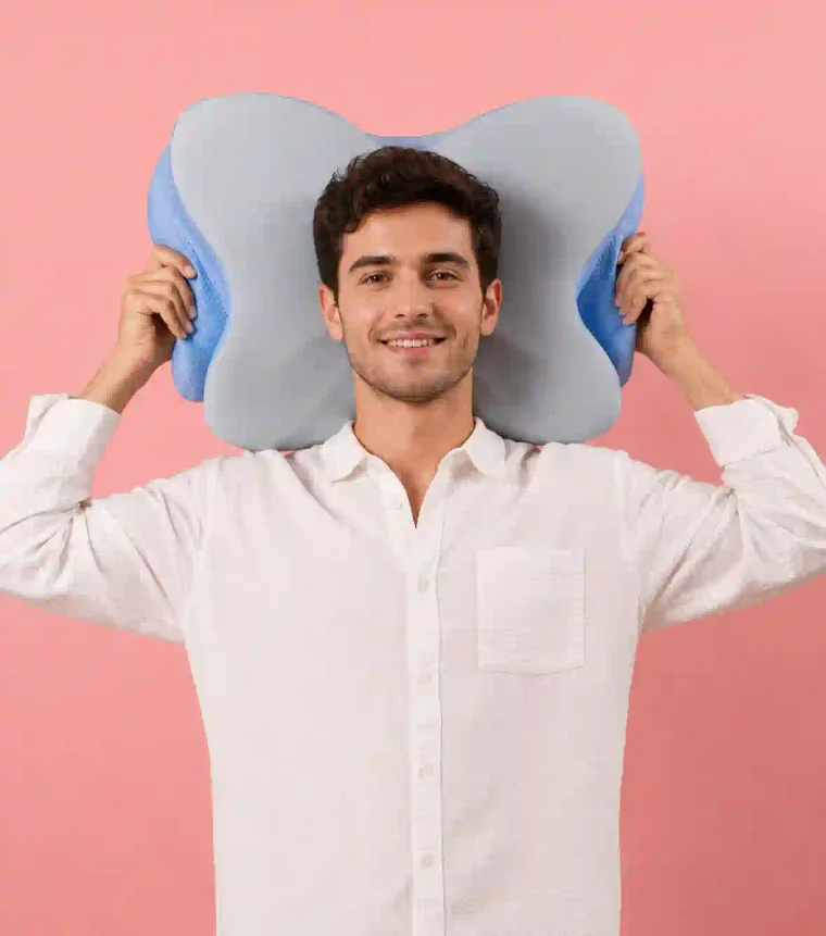 Person holding the Derila Ergo pillow, showing its compact size against the upper body