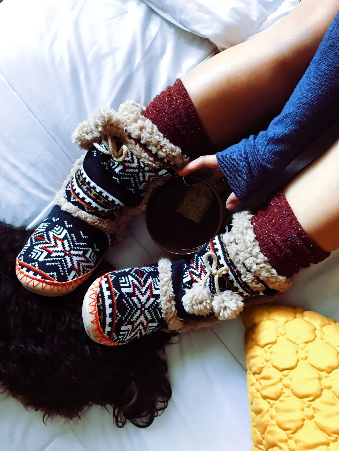 Cozy bedroom setup with warm slippers and blanket — the kind of setup an oil-filled radiator fits into overnight