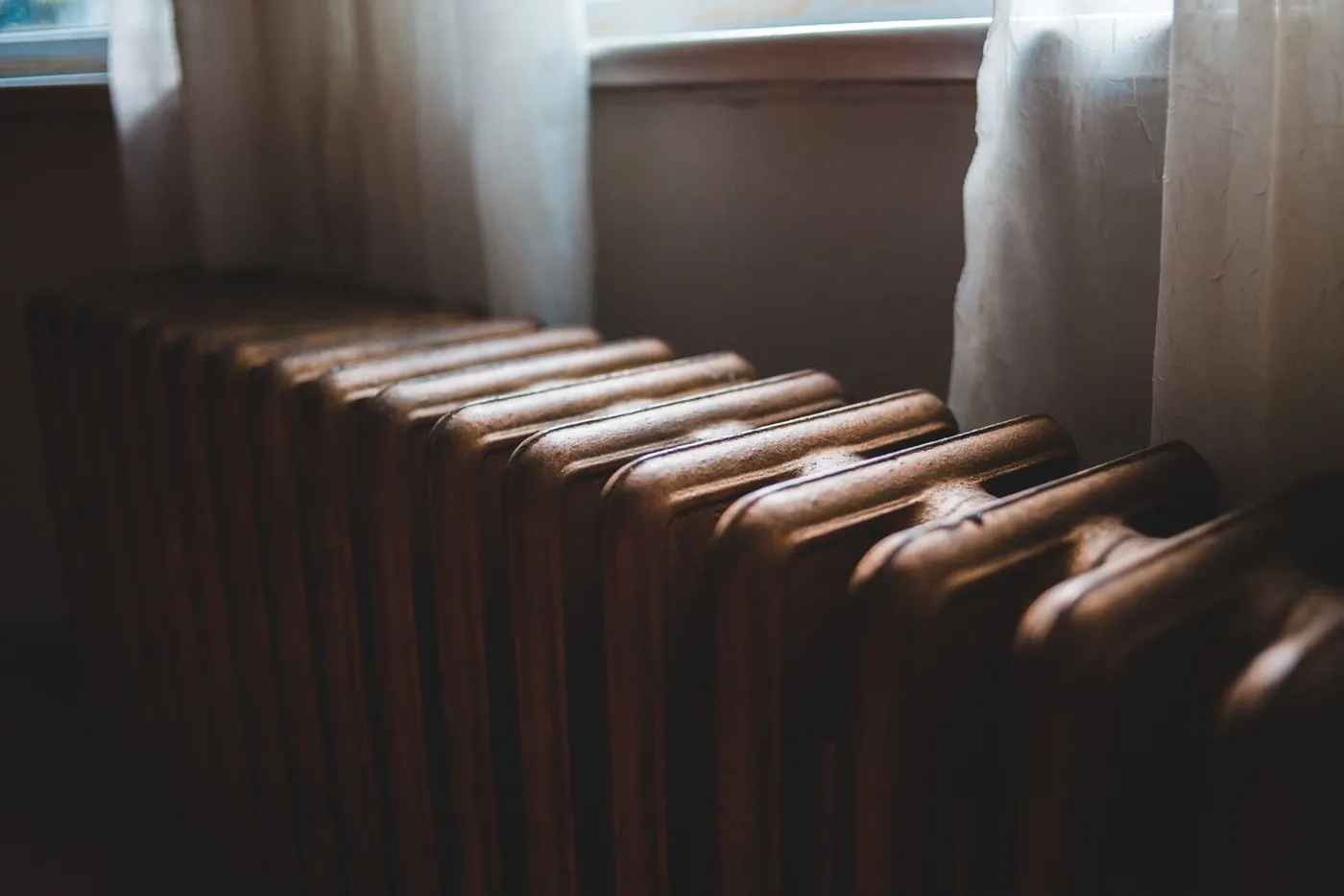 Small oil-filled radiator heater sized for a bedroom, running at a lower wattage setting