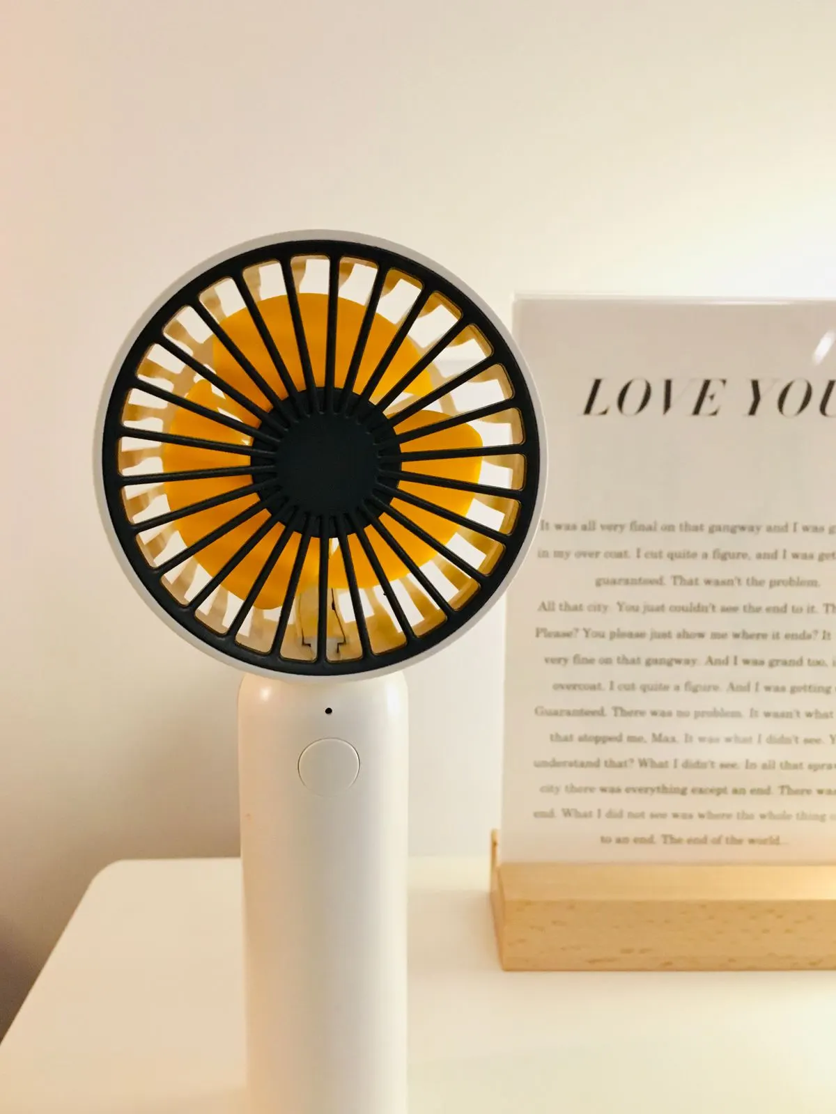 Portable evaporative air cooler next to a window in a bright summer room