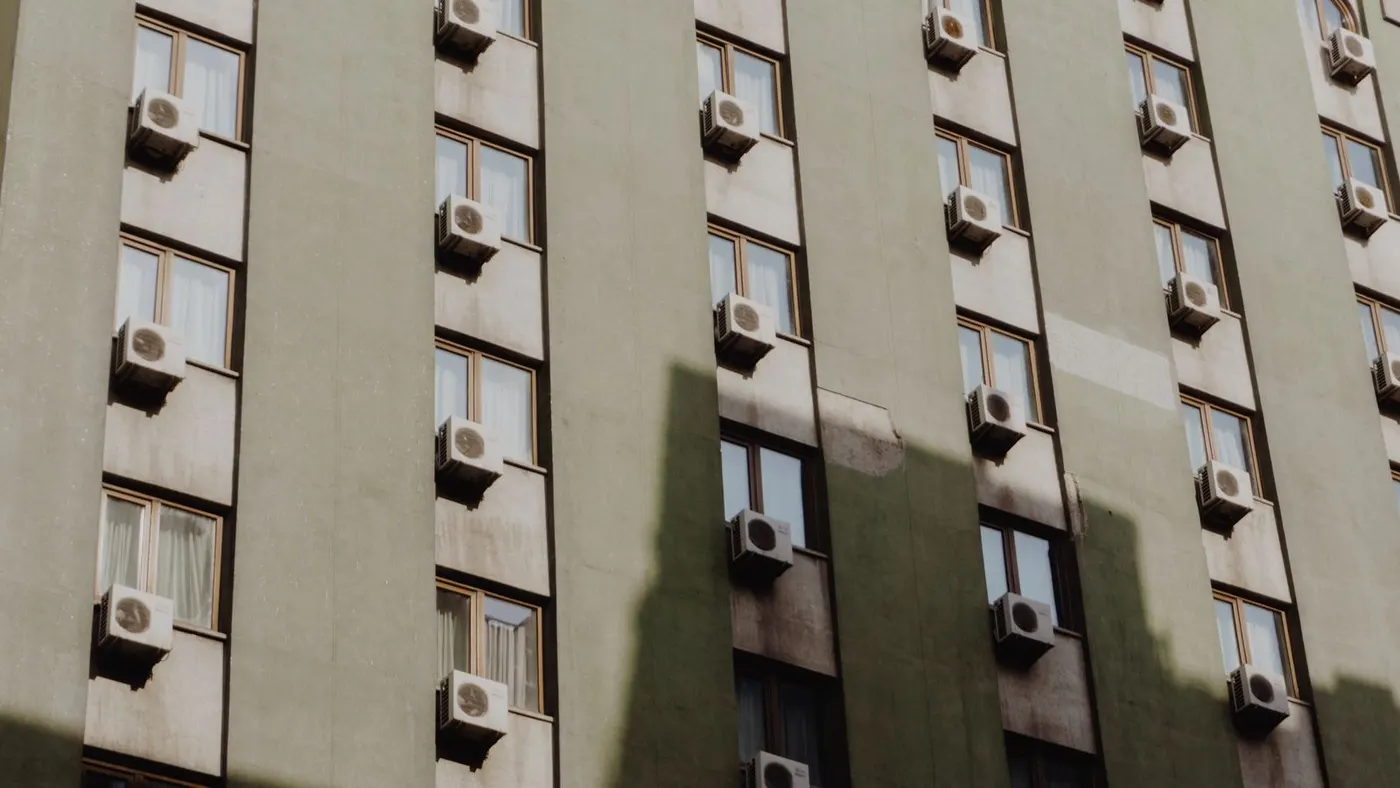 Air conditioner mounted in a city apartment window — the same hose principle applies to portable AC installs